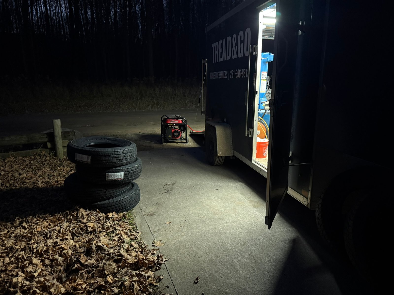 Outside Tread & Go mobile tire service trailer at night